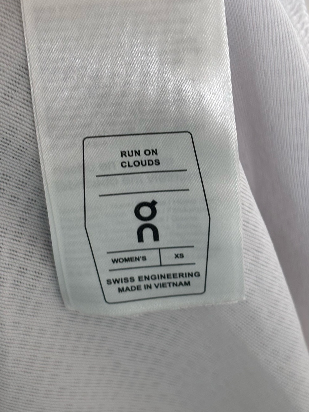 On Running Women’s White Tank Top with Black and Lavender Stripe Accent - Picture 3 of 3